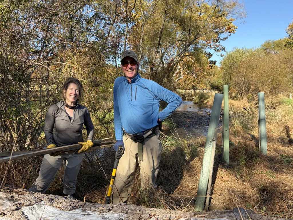 Volunteers doing tree maintenance along the West Branch of the Perkiomen Creek at Longacres Farm